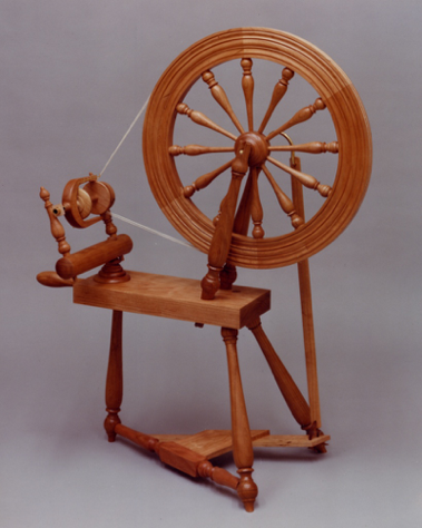 Spinning Wheel: a Cherry flax style wheel set up to spin wool.